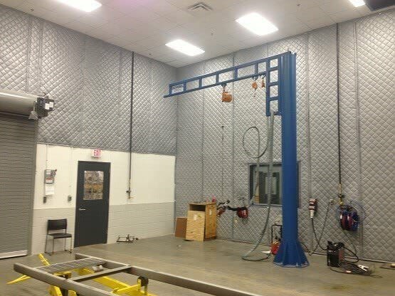 A garage full of noise absorption panels on the walls.