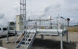 An elevated industrial equipment platform with access stairs