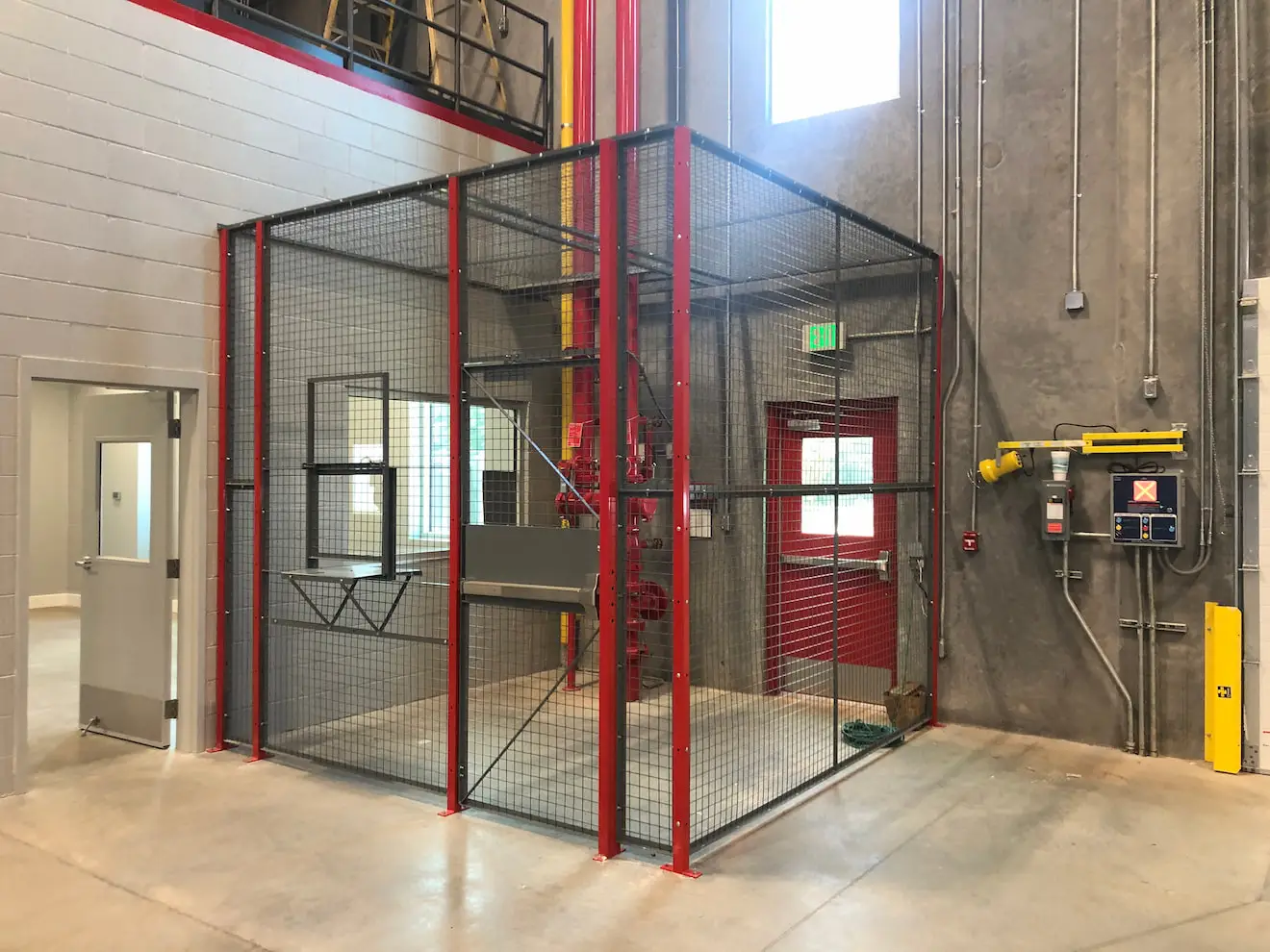 Wire mesh partition designed by KABTech with red, black, and yellow colors