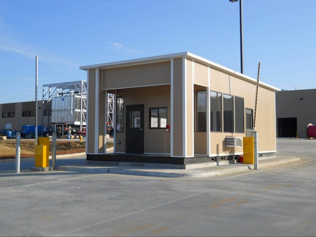 An modern entrance guard shack provides security for a manufacturing plant