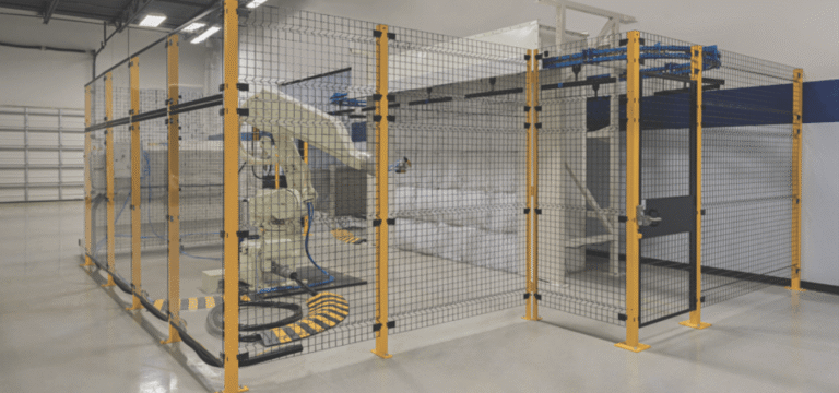 Yellow wire mesh partition guarding dangerous equipment in a facility