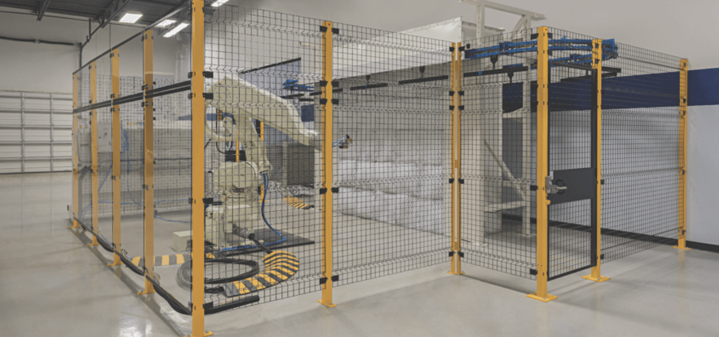 Yellow wire mesh partition guarding dangerous equipment in a facility