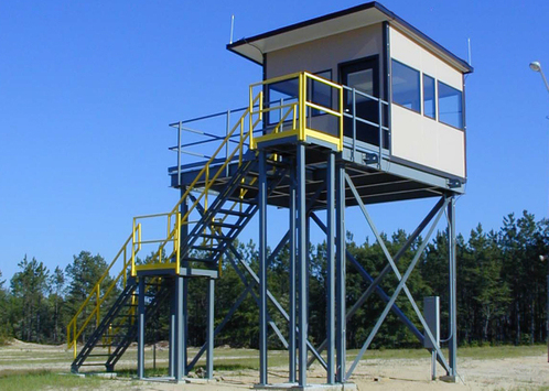 A raised security guard shack with a set of staircases